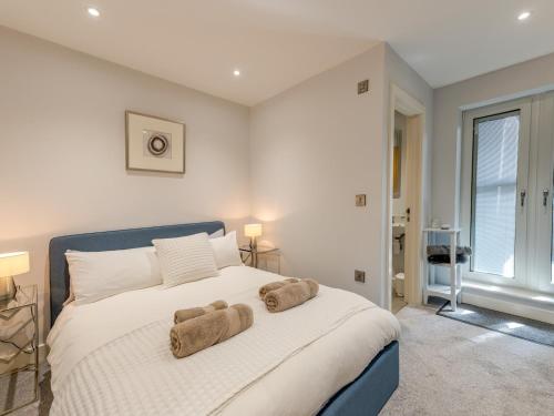 a bedroom with a large white bed with towels on it at Pass the Keys 40C 2 bed Celosia Beautiful Town Centre Apartment in Shrewsbury