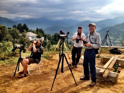 a group of people with cameras on a mountain at PAPILLON in Chakvi