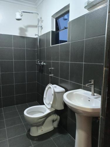 La salle de bains est pourvue de toilettes et d'un lavabo. dans l'établissement Riverside 001, à Nanyuki