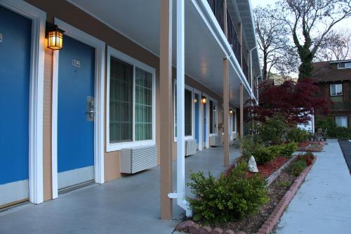 a building with blue walls and a walkway at The Angler Lodge in Dunsmuir
