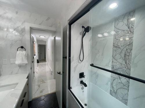 a bathroom with a shower with a glass door at Luxury Smart Home ~ Perfect Getaway Resort/Sleeps 14 in Langley