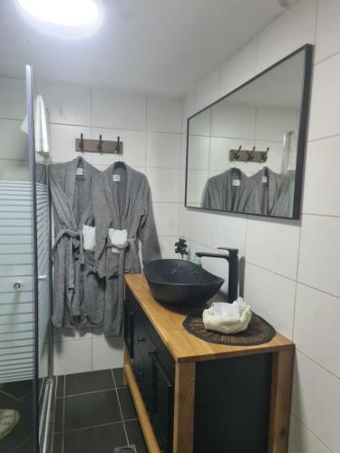a bathroom with a sink and a mirror at ronit's place in Qiryat Shemona