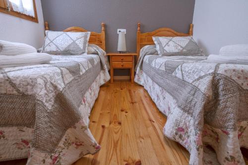 two beds sitting next to each other in a bedroom at LA GINESTA 2, Apartaments de muntanya in Taull