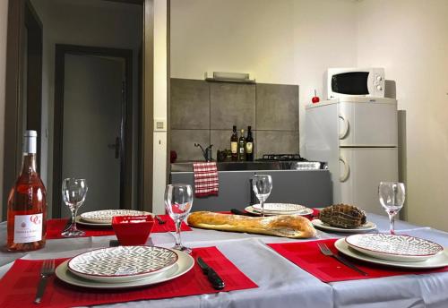 a table with plates and glasses and a bottle of wine at U FARNIENTE in Bonifacio