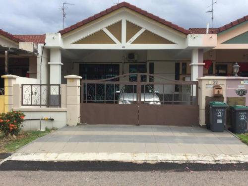 a house with a gate in front of it at June's Homestay@ Puteri Wangsa near Aeon & IKEA in Ulu Tiram