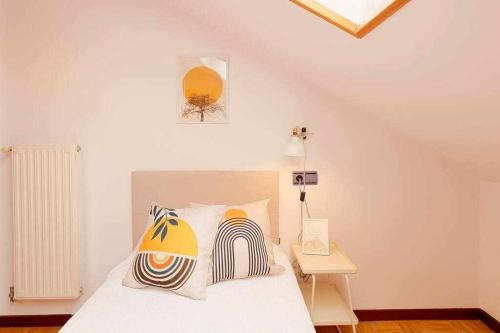 a white bedroom with a bed and a table at Coto Salinas Apartamento in Salinas