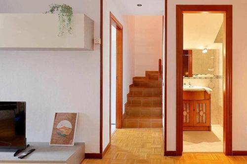 a living room with a staircase leading to a bathroom at Coto Salinas Apartamento in Salinas