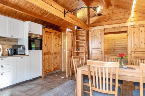 a kitchen and dining room of a cabin with a table and chairs at Ferienhaus in Noer
