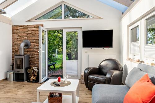 a living room with a couch and a tv at Ferienhaus in Noer