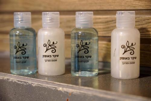 a group of four bottles of milk on a counter at סוויטות רומאנס - סוויטות מהממות לזוגות ומשפחות in Metulla