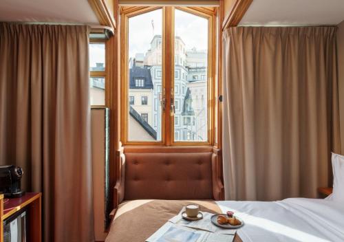 a hotel room with a bed and a window at Berns, Historical Boutique Hotel & House of Entertainment since 1863 in Stockholm