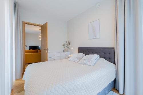 a bedroom with a white bed with two pillows at Cozy Stay Apartment in Pärnu