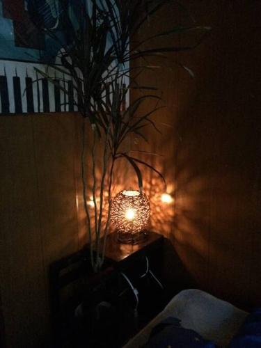 a lamp on a table with a vase on it at 【MEMS】1人から貸切OK!駐車場1台付き!那覇空港から車で13分！ in Takara