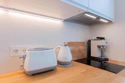 a kitchen with two appliances sitting on a counter at Cozy Stay Apartment in Pärnu