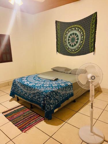 a bedroom with a bed and a rug and a fan at Around JSM Granada in Granada