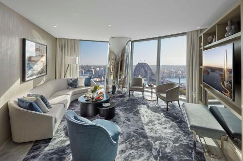a living room with a couch and chairs and a large window at Crown Towers Sydney in Sydney