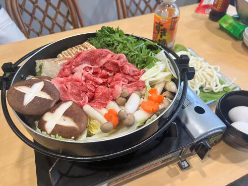 a grill with meat and vegetables on a table at 雪场缆车站旁 Hotel Justice-Ski IN Ski OUT-独立卫浴 in Seki