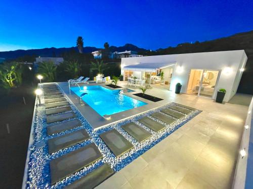 a villa with a swimming pool at night at Casa Tajuya in Los Llanos de Aridane