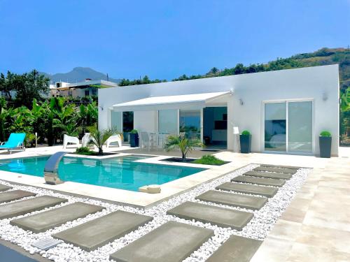 a villa with a swimming pool and a house at Casa Tajuya in Los Llanos de Aridane