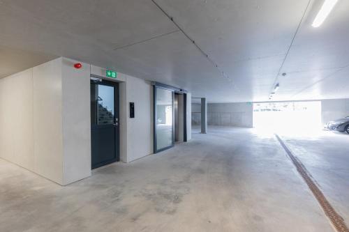 an empty hallway of an office building with doors at Cozy Stay Apartment in Pärnu
