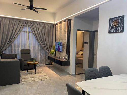 a living room with a room with a ceiling fan at Home Sweet Home 2 rooms Apartment in Melaka