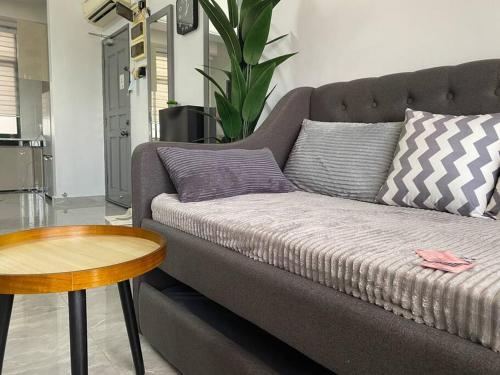 a living room with a couch and a table at Home Sweet Home 2 rooms Apartment in Melaka