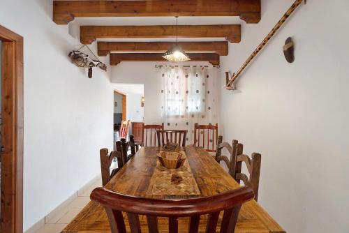 a dining room with a wooden table and chairs at Casa Rural Medina 1 in Agulo