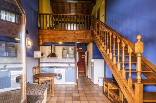 a staircase in a house with a blue wall at Centro de Turismo Rural La Coruja del Ebro in Valderredible