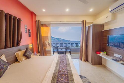 a bedroom with a bed with a view of the ocean at Polsburg Panchgani in Panchgani