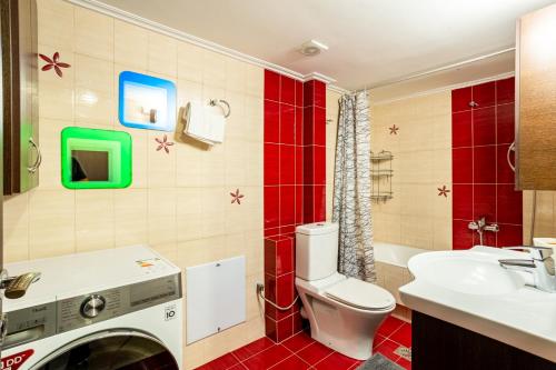 a bathroom with a toilet and a sink at Grand Luxury Apartment Seafront Kalamata in Kalamata
