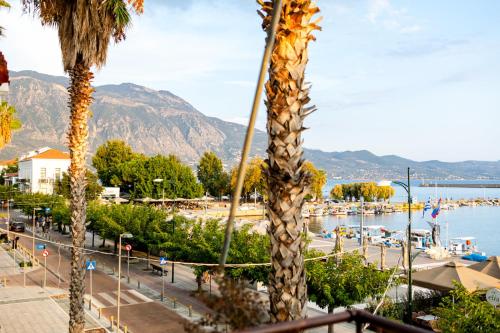 a view of a beach with a palm tree at Grand Luxury Apartment Seafront Kalamata in Kalamata