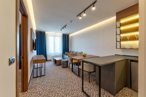 a hotel room with a kitchen and a living room at Queen of Zlatibor in Zlatibor