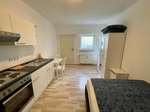 a kitchen with a sink and a stove top oven at Appartement im Zentrum von Baienfurt in Baienfurt