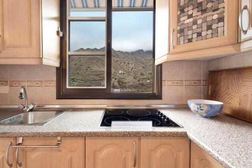 a kitchen with a sink and a window with a view at La Huerta in Hermigua