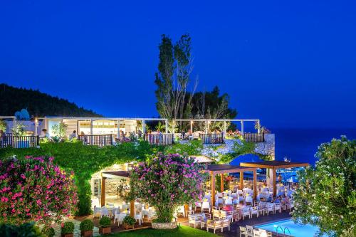 a view of a resort with tables and chairs at Skiathos Palace Hotel in Koukounaries