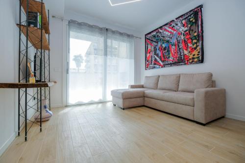 a living room with a couch and a large window at BergamoCityCenter 04 in Bergamo