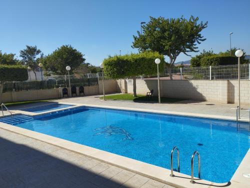 a large swimming pool with blue water at APARTAMENTO NEPTUNO - CANET DE BERENGUER in Canet de Berenguer
