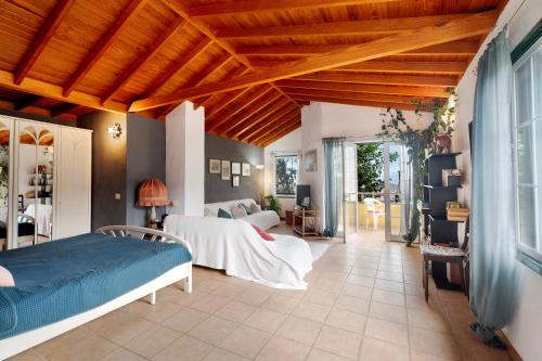 a bedroom with a bed and a living room at Casa Claudia in Hermigua