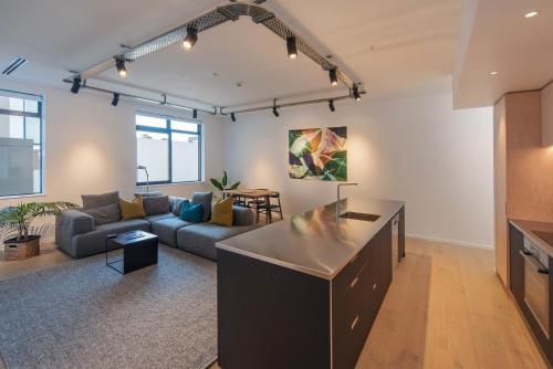 a living room with a couch and a table at Inner City Apartments - 1 in Nelson