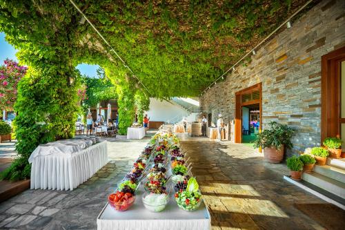 a display of flowers on a table in front of a building at Skiathos Palace Hotel in Koukounaries