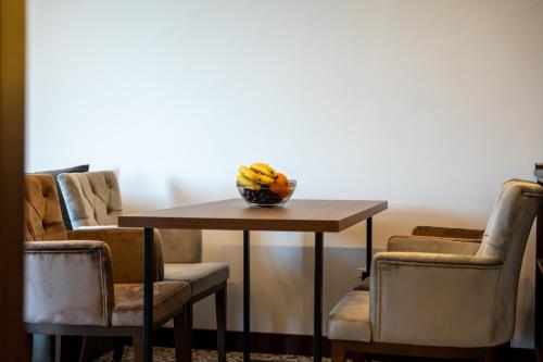 a table and chairs with a bowl of bananas on it at Queen of Zlatibor in Zlatibor