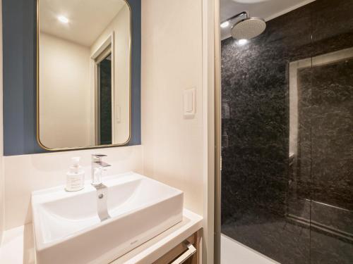 a bathroom with a sink and a shower at Oriental Hotel Tokyo Bay in Urayasu