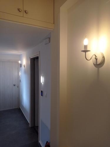 a hallway with a light fixture on a wall at Marousos Central Guesthouse in Portariá
