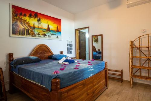 a bedroom with a bed with flowers on it at Beachfront Villa Thamani with Private Pool and Beach ZanzibarHouses in Pwani Mchangani