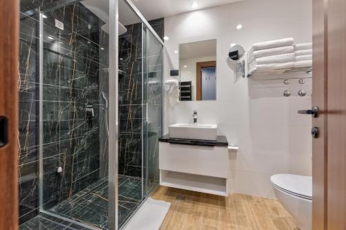 a bathroom with a shower and a sink and a toilet at Queen of Zlatibor in Zlatibor