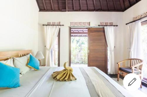 Postel nebo postele na pokoji v ubytování Ary House Ubud