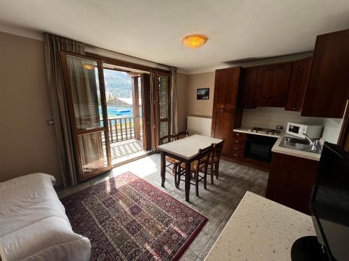 a kitchen with a table and a dining room with a view at Chalet Edelweiss - Estella Hotel Collection in Sestriere