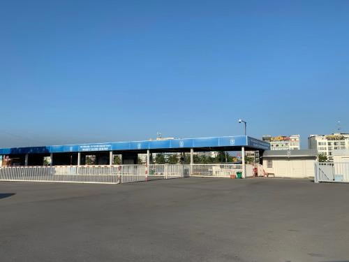a building with a blue roof next to a parking lot at Tuần Châu - Phương Đông Motel Hạ Long in Ha Long