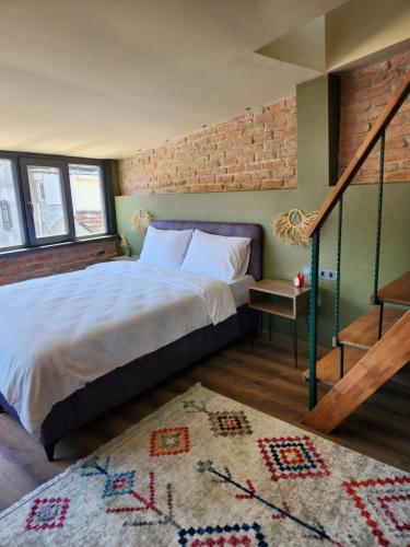 a bedroom with a bed and a brick wall at Karaköy in Karaköy in Istanbul