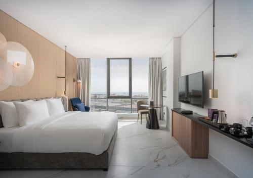 a hotel room with a bed and a television at JOUDYAN Red Sea Mall Jeddah By ELAF in Jeddah